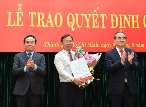 Bí Thư Thành ủy TP HCM Nguyễn Thiện Nhân và Phó Bí thư Thường trực Thành ủy TP HCM Trần Lưu Quang trao quyết định, chúc mừng ông Huỳnh Khắc Điệp. Ảnh: SGGP.