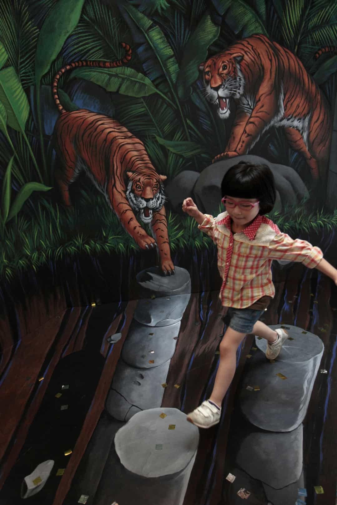 Một cô gái trẻ đang giữ thăng bằng để thoát khỏi hổ, trong một tác phẩm khác của Tracy Lee Stum.  