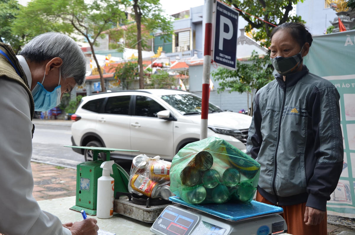 Bà Thanh mang phế liệu ra phiên chợ để đổi lấy rau, củ quả cho bữa trưa. 