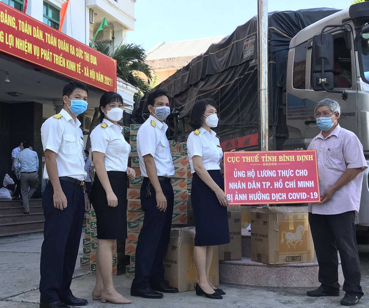Ông Hồ Sĩ Dũng, Phó Chủ tịch, Ủy ban MTTQ Việt Nam tỉnh Bình Định, tiếp nhận hỗ trợ nhu yếu phẩm từ Cục Thuế tỉnh Bình Định.