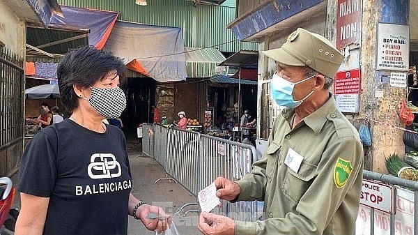 Người dân phải có thẻ mới được vào chợ mua thực phẩm.