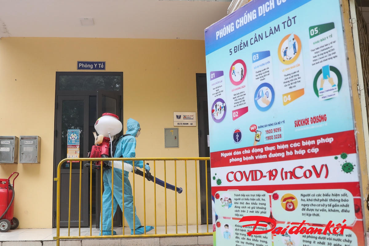 Công tác phun khử khuẩn được thực hiện tại sân trường, các hành lang. Ảnh: Quang Vinh.