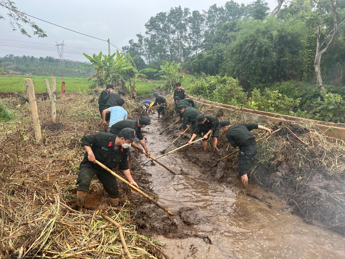 Lực lượng Công an đang khơi thông dòng chảy tại  cánh đồng của buôn Đrao và buôn Ktâng Đrun (xã Cư Né) 
