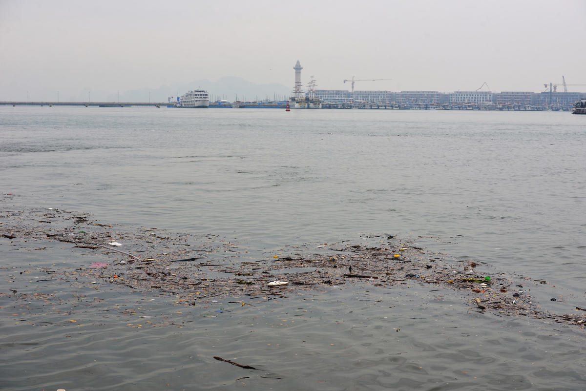 Rác trôi nổi trên mặt biển có đủ chủng loại, từ cây cối, chai nhựa cho đến túi nilon và cuộn theo rác là dòng nước đục ngầu.