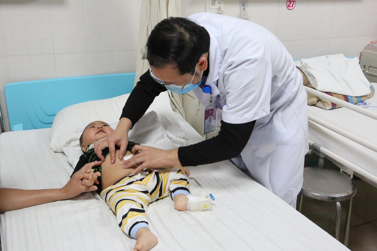 Bác sĩ thăm khám cho trẻ sau phẫu thuật.