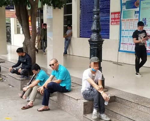 Những người lái xe ôm và phụ xe khách thường tụ tập thành từng nhóm ngồi tán ngẫu cũng không đeo khẩu trang.