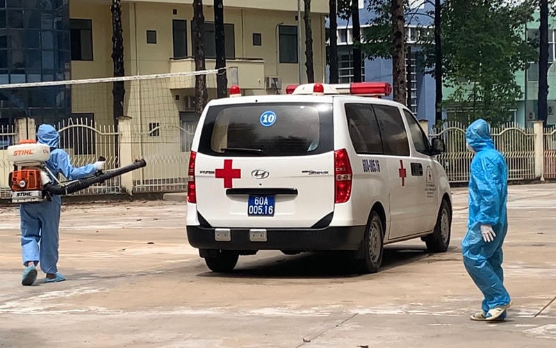 Phun khử khuẩn xe vận chuyển các trường hợp F1 đến KCL tại KTX Đại học Đồng Nai. Ảnh: CDC 