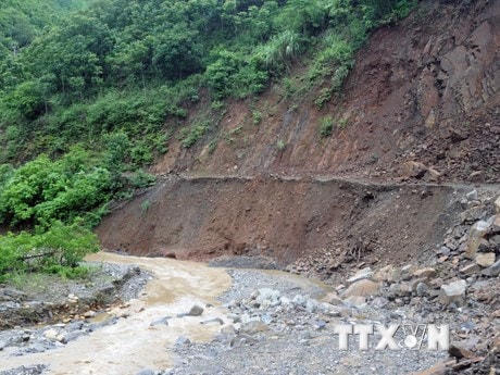Một tuyến đường nối với trung tâm xã bị sạt lở, nước dâng cao khiến giao thông gặp nhiều khó khăn. (Ảnh: Quang Quyết/TTXVN).