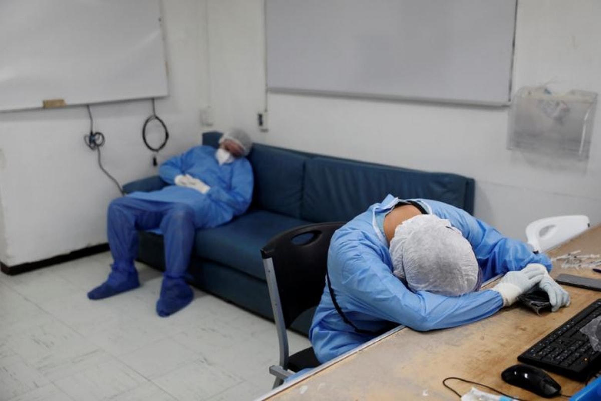 Các nhân viên y tế trong trang phục bảo hộ đang nghỉ ngơi sau nhiều giờ làm việc tại phòng chăm sóc tích cực ở bệnh viện Juarez de Mexico ngày 29/10.  