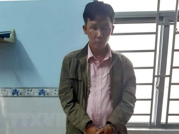 Đối tượng Trần Minh Thành bị bắt giữ cùng các tang vật. (Ảnh: TTXVN phát).