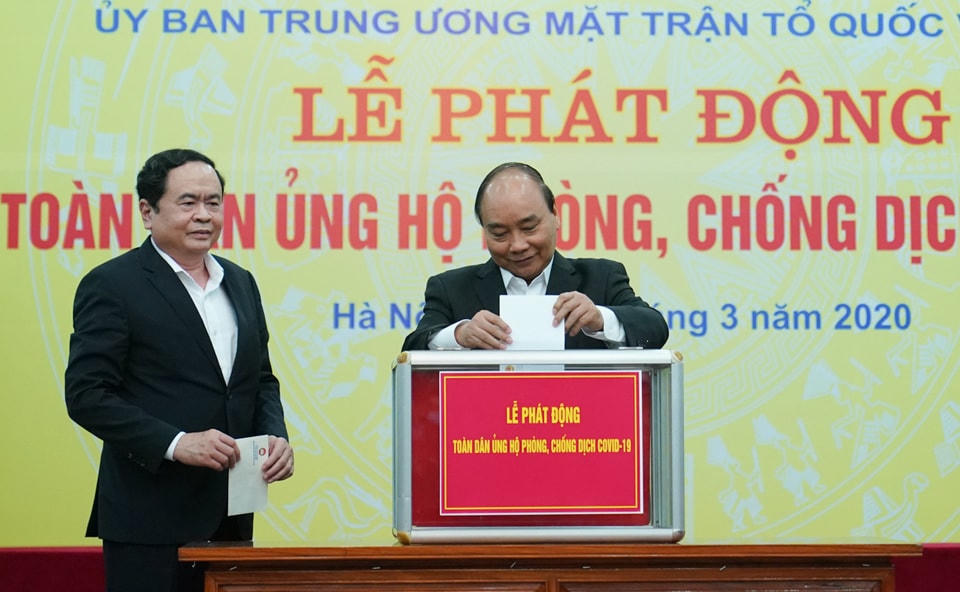 Thủ tướng Chính phủ Nguyễn Xuân Phúc và Bí thư Trung ương Đảng, Chủ tịch UBTƯ MTTQ Việt Nam Trần Thanh Mẫn ủng hộ người nghèo, tại Lễ phát động toàn dân ủng hộ phòng, chống dịch Covid-19 do UBTƯ MTTQ Việt Nam tổ chức, ngày 17/3/2020. Ảnh: VGP.