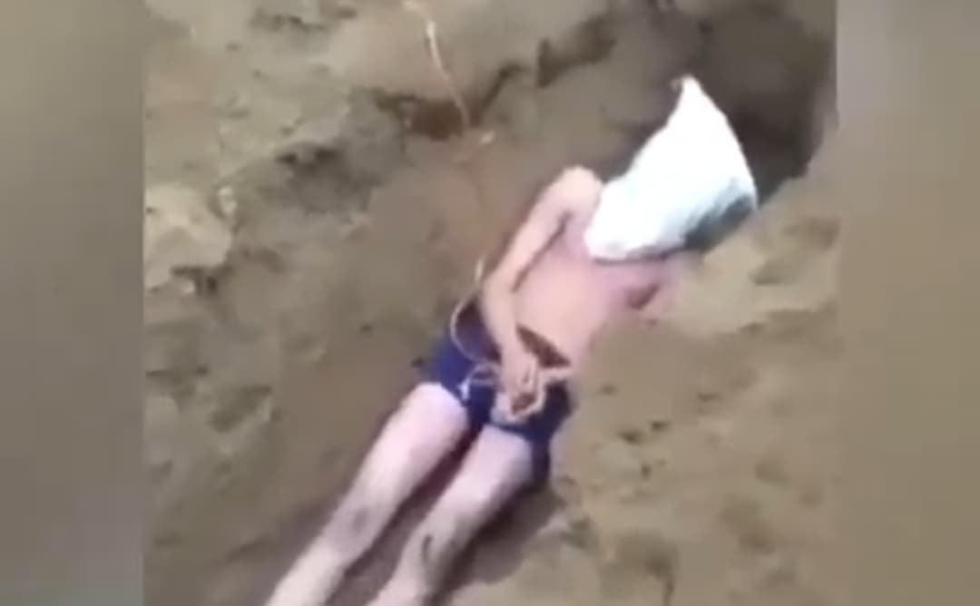 Nam thanh niên bị trùm đầu, sau đó bị nhóm đối tượng chôn sống kêu khóc van xin.