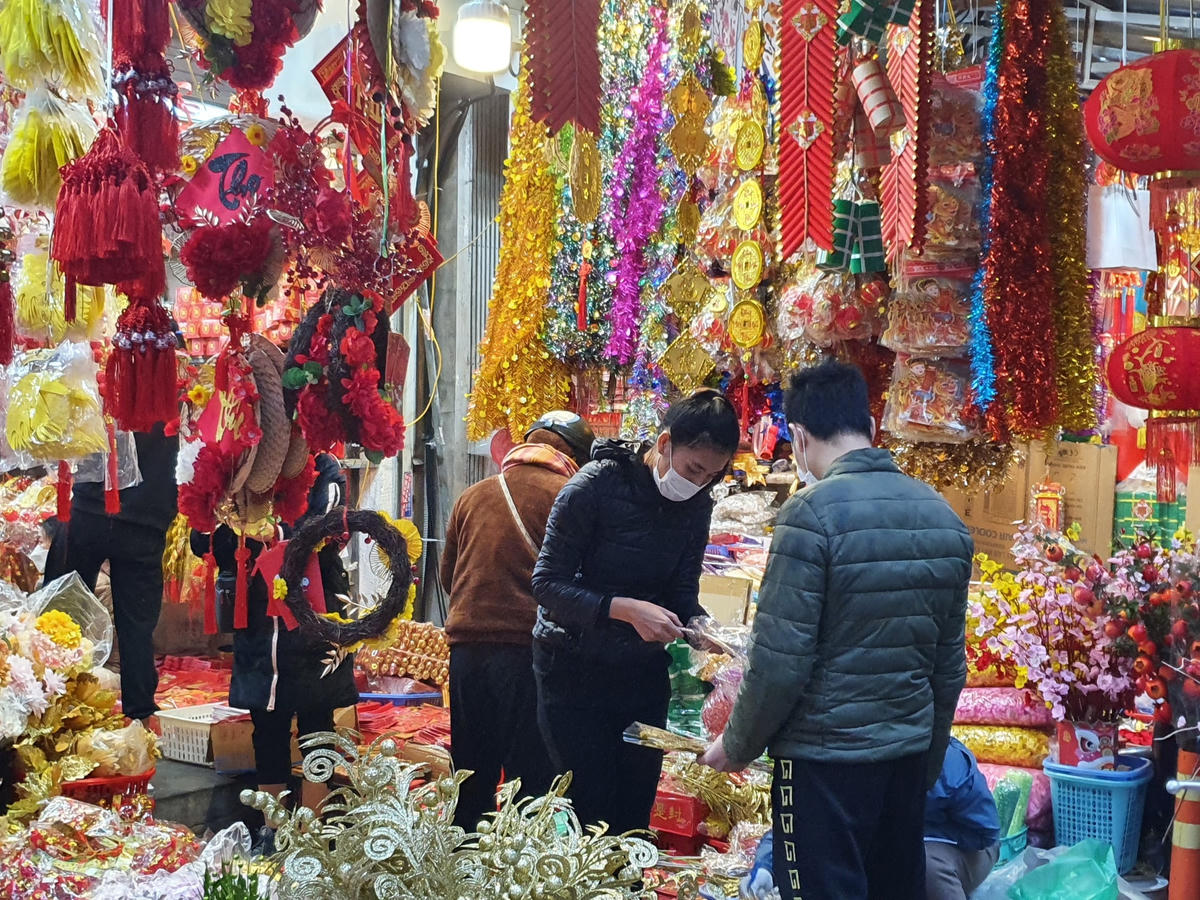 Người dân mua sắm Tết tại phố Hàng Mã (Hà Nội).