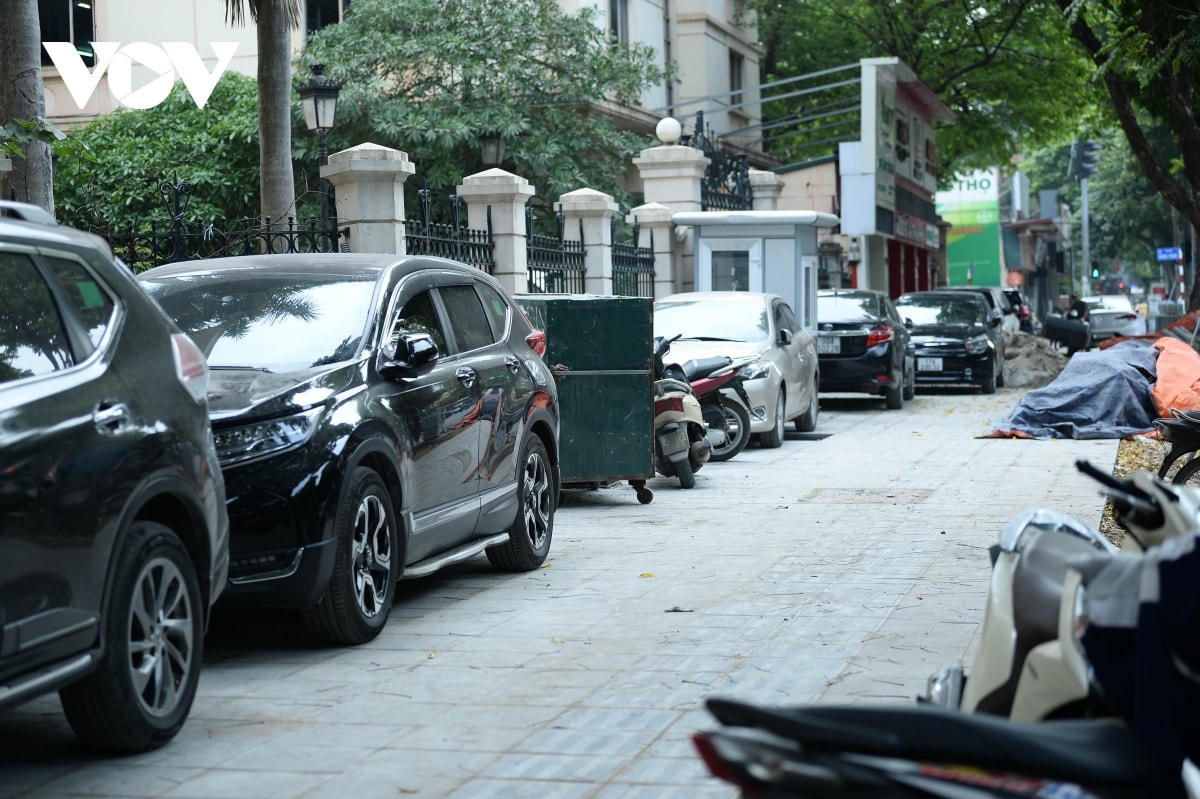 Trước cửa số nhà 52 phố Hai Bà Trưng, có tới hàng chục ô tô cố tình leo lên đậu mặc dù vỉa hè này chưa thi công xong.  