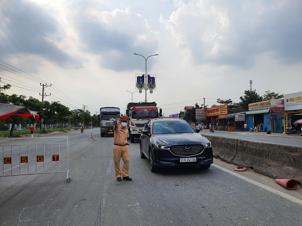 CSGT tỉnh Bà Rịa-Vũng Tàu hướng dẫn người điều khiển các phương tiện thực hiện các thủ tục cơ bản trước khi vào tỉnh. Ảnh: N.L.