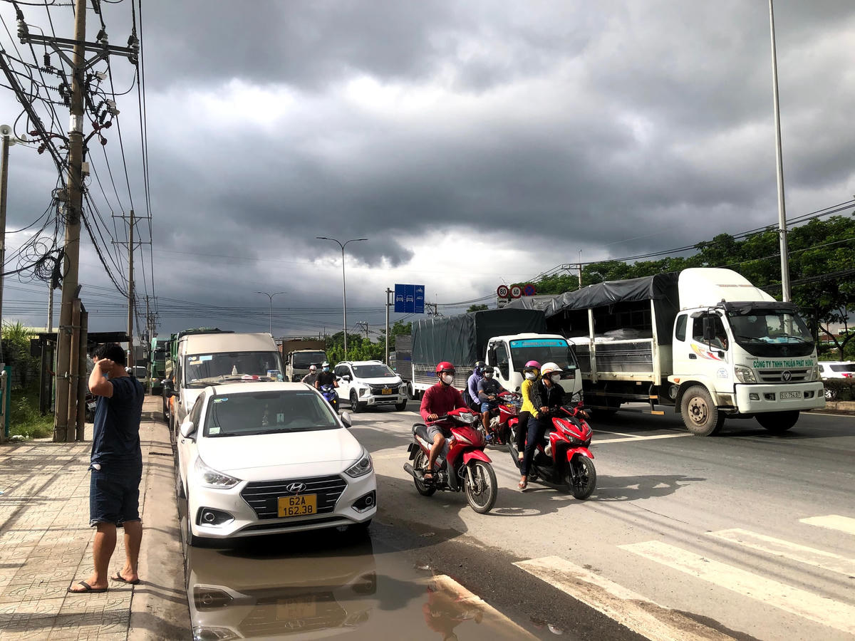 Dọc quốc lộ 22 ở cổng bệnh viện, khoảng hơn 100 phương tiện ôtô tải, xe chạy dịch vụ đưa đón, xe cá nhân.. đang đậu hàng dài vì tài xế đang đợi kết quả xét nghiệm.