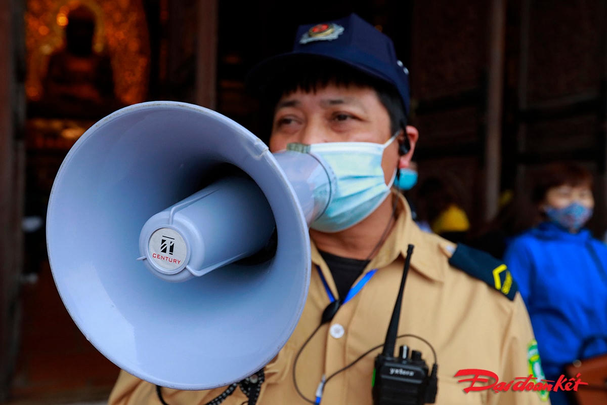 Ban tổ chức dùng loa công suất lớn nhắc nhở người dân giữ khoảng cách, thường xuyên đeo khẩu trang để phòng dịch.