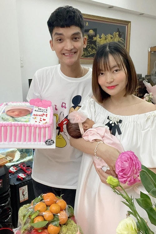 Mạc Văn Khoa và Thảo Vy trong lễ đầy tháng con ở TP HCM. Tết này, gia đình anh không thể về Hải Dương đón Tết cùng bố mẹ. (Ảnh NVCC).