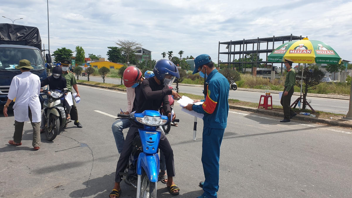 Hướng dẫn người dân điền thông tin vào tờ khai y tế.