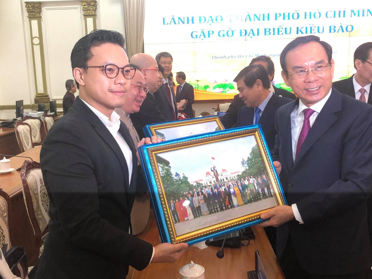 Bí thư Thành ủy TP HCM Nguyễn Văn Nên tặng bức tranh lưu niệm của thành phố cho đại biểu kiều bào (Ảnh: Hồng Phúc).