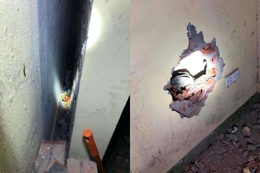 Khe tường giữa 2 nhà cháu bé bị bỏ rơi và bức tường lực lương Công an đục để giải cứu cháu bé.