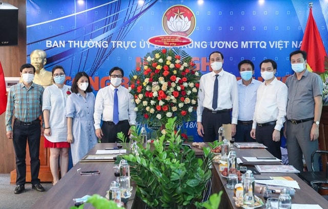 Phó Chủ tịch Phùng Khánh Tài trao lẵng hoa của Bí thư Trung ương Đảng, Chủ tịch UBTƯ MTTQ Việt Nam Đỗ Văn Chiến chúc mừng Quyền Tổng Biên tập báo Đại Đoàn Kết Lê Anh Đạt. Ảnh: Quang Vinh.