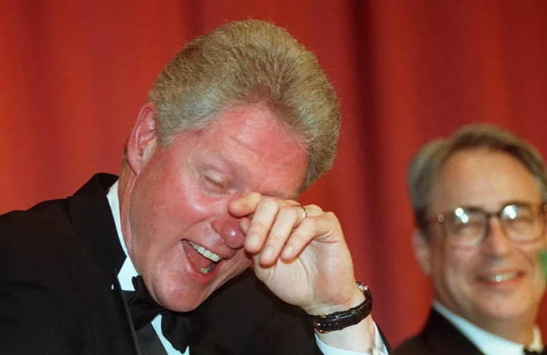Cựu Tổng thống Mỹ Bill Clinton cười chảy nước mắt khi ông và Chủ tịch Hiệp hội Phóng viên Nhà Trắng Carl P. Leubsdorf khi nghe diễn viên hài Al Franken chọc cười trong bữa tối thường niên của hiệp hội ở Washington DC, năm 1996.