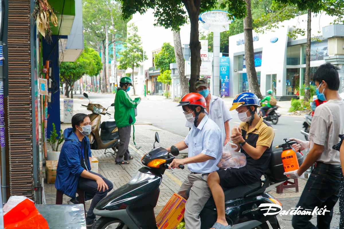 Người dân sinh sống trong khu phố, mỗi khi ra vào, đều phải được phun thuốc diệt khuẩn.