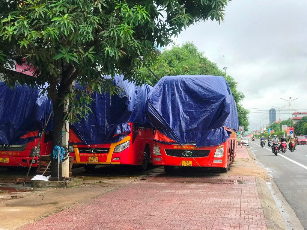4 chiếc xe giường nằm của nhà xe Dũng Thu trùm kín bạt.
