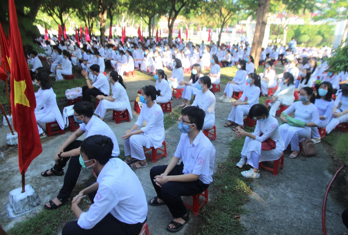 Các em học sinh đeo khẩu trang dự lễ khai giảng.