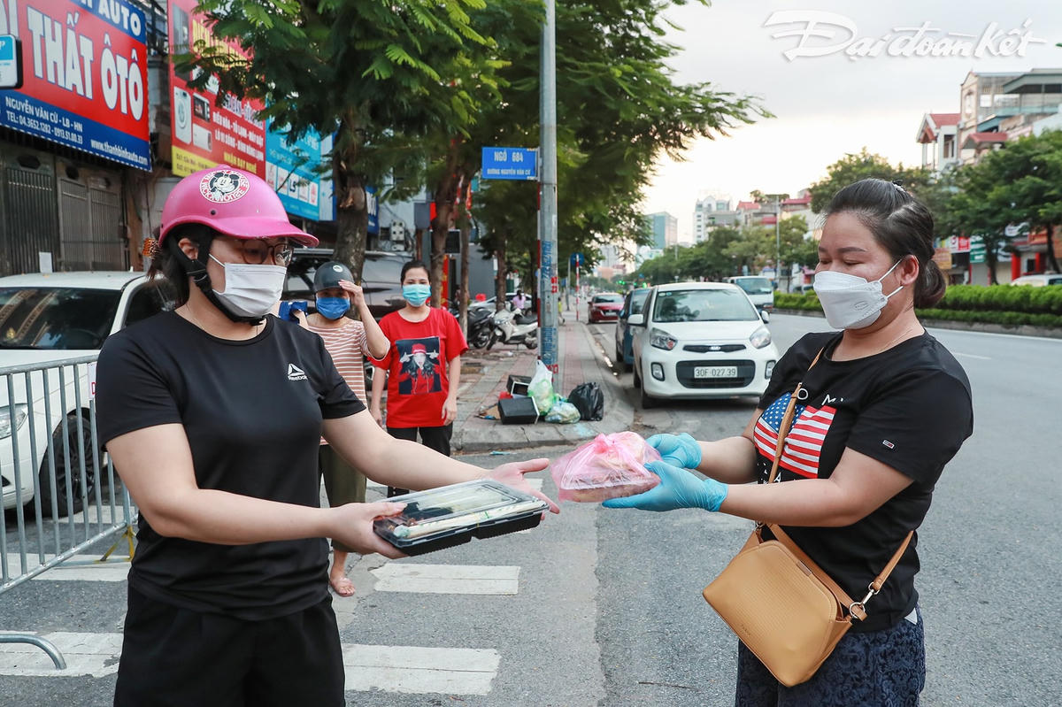 Những thành viên đội tình nguyện cùng gửi tới những người khó khăn suất ăn từ thiện. Ảnh: Quang Vinh. 