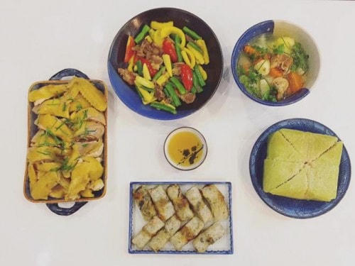 Mâm cỗ đơn giản, ấm cúng bao gồm: Thịt gà luộc; thịt bò xào ngô bao tử, đậu cove, ớt chuông; canh khoai tây cà rốt ninh sườn; nem rán và bánh chưng.