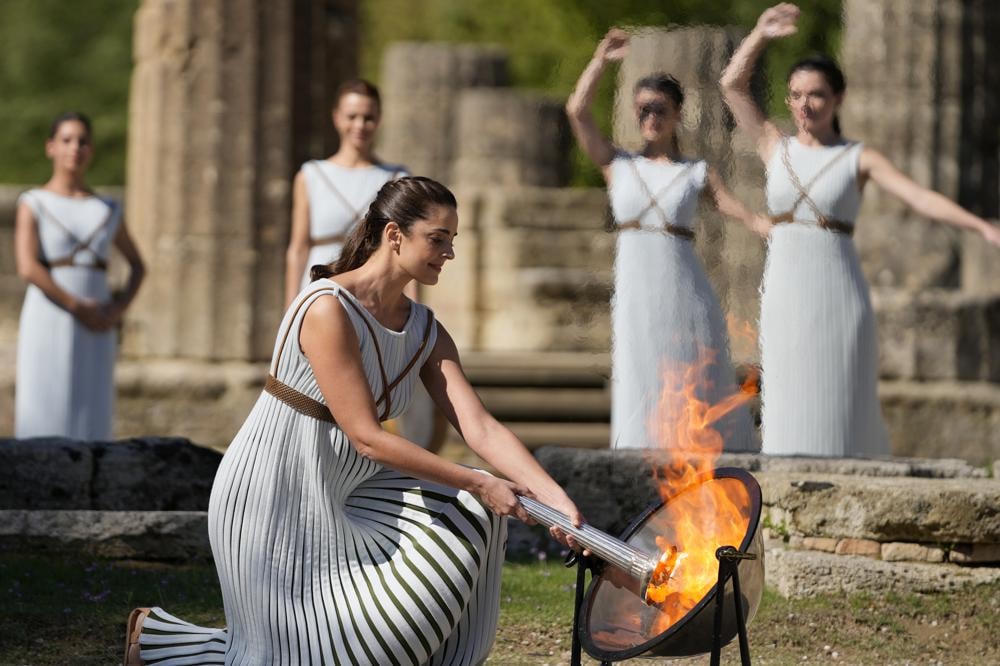 Nữ diễn viên người Hy Lạp Xanthi Georgiou, đóng vai Nữ tư tế tối cao, thắp sáng ngọn đuốc Olympic ở sân vận động Olympia cổ đại, nơi khai sinh ra Thế vận hội cổ đại ở phía tây nam Hy Lạp. Ngọn lửa sẽ được vận chuyển rước đuốc đến thủ đô Bắc Kinh, Trung Quốc, nơi sẽ tổ chức Thế vận hội Mùa đông từ ngày 4 đến ngày 20/02/2022. Ảnh: AP/Thanassis Stavrakis.