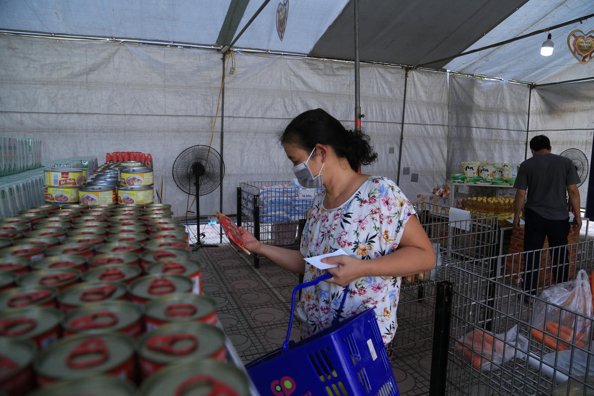 Bà Nguyễn Thị Hường chọn mua những thực phẩm thiết yếu, gia đình còn thiếu.