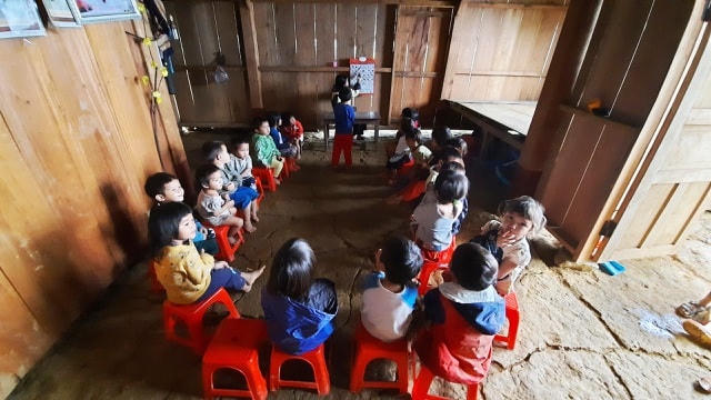 Các em lớp mẫu giáo học nhờ ở một nhà dân khác.  