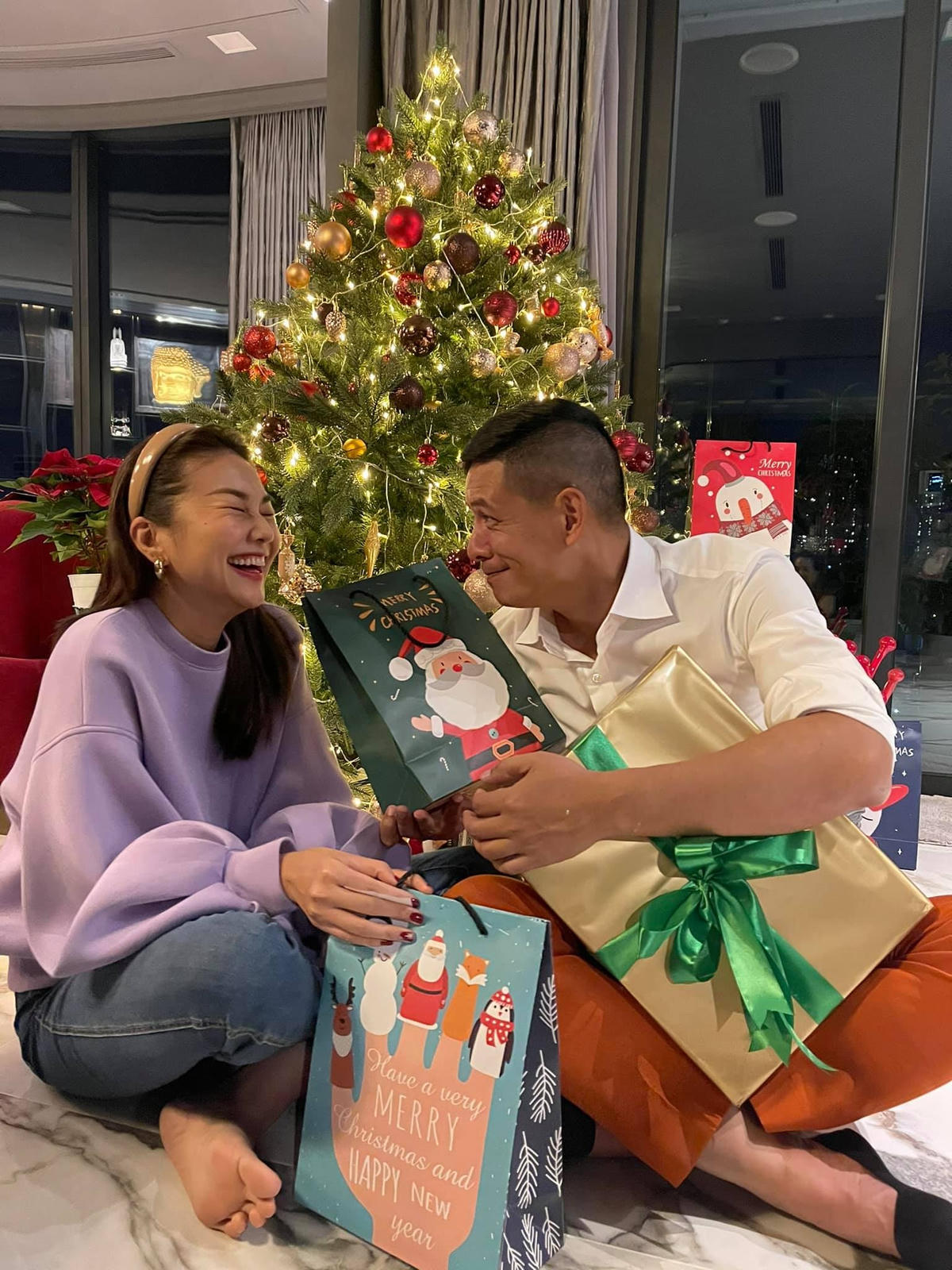 Thanh Hằng cười tít mắt khi được đàn anh Bình Minh tặng quà Giáng sinh.