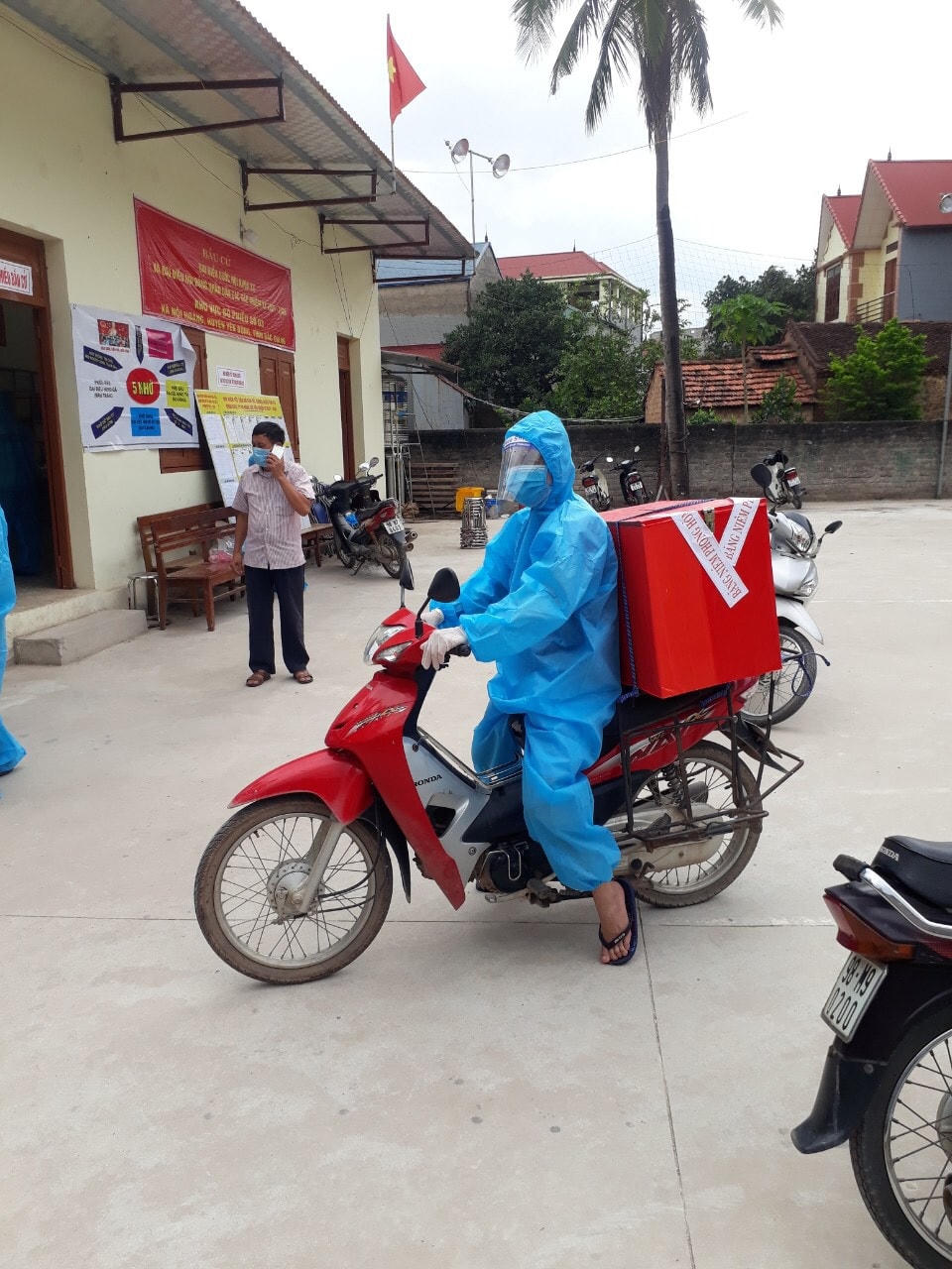 Thùng phiếu được buộc sau xe máy để đến cử tri ở khu vực cách ly xã Nội Hoàng, huyện Yên Dũng.