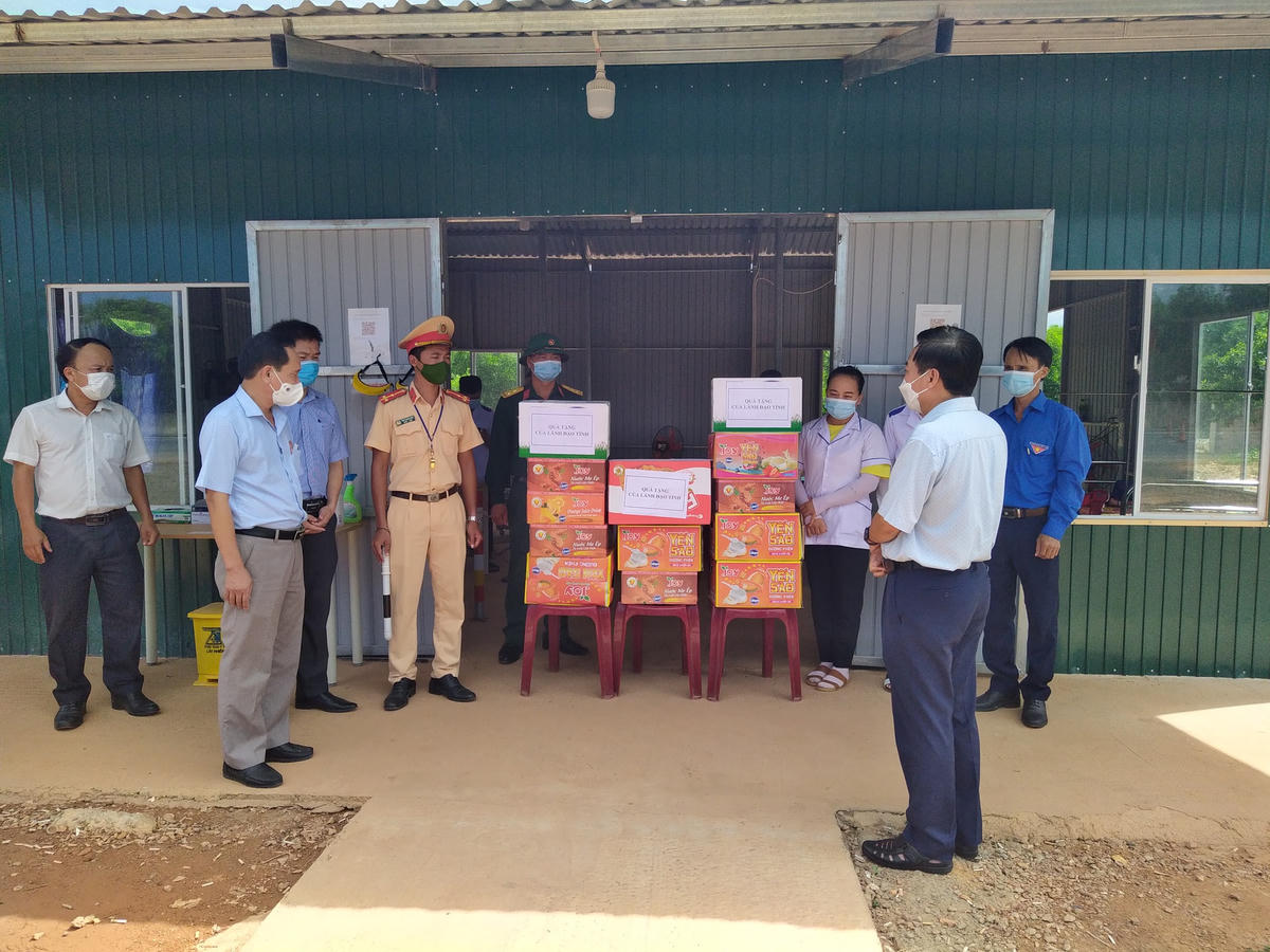 Ông Đạo Mạnh Hùng (bên phải) thay mặt lãnh đạo tỉnh Quảng Trị tặng quà các lực lượng làm nhiệm vụ tại chốt kiểm soát y tế tại xã Vĩnh Chấp.