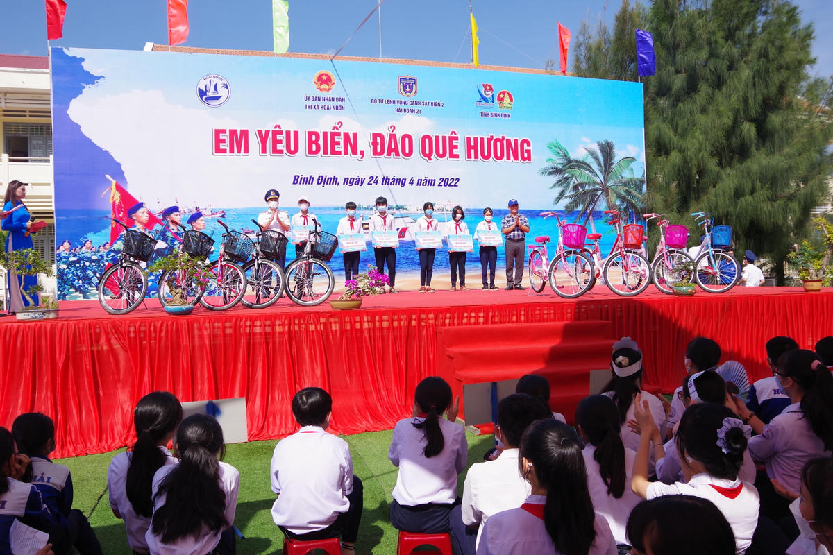 Đại tá Lê Phúc Tiến chính ủy Hải đoàn 21, tặng xe đạp cho các em học sinh.