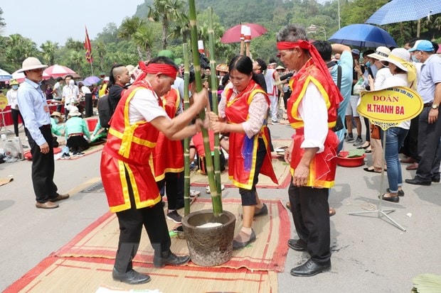 Các đội tham gia phần thi giã bánh giầy. (Ảnh: Trung Kiên/TTXVN).