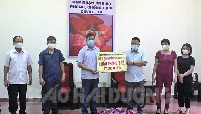 Lãnh đạo Công ty CP Môi trường và Xây dựng Nguyên Vũ (Hải Dương) trao khẩu trang y tế phục vụ công tác phòng chống dịch Covid-19. Ảnh: Báo Hải Dương.