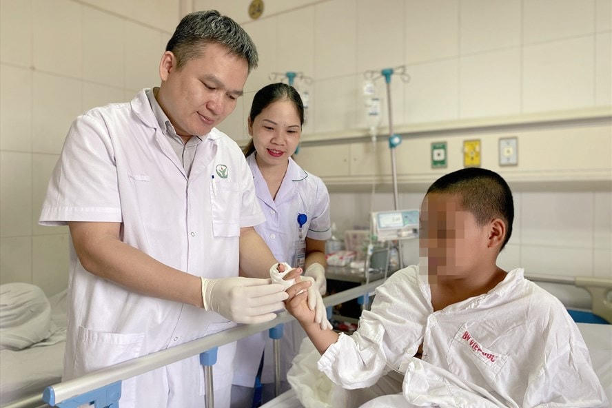 Bác sỹ kiểm tra ngón tay của bệnh nhân sau khi phẫu thuật. 