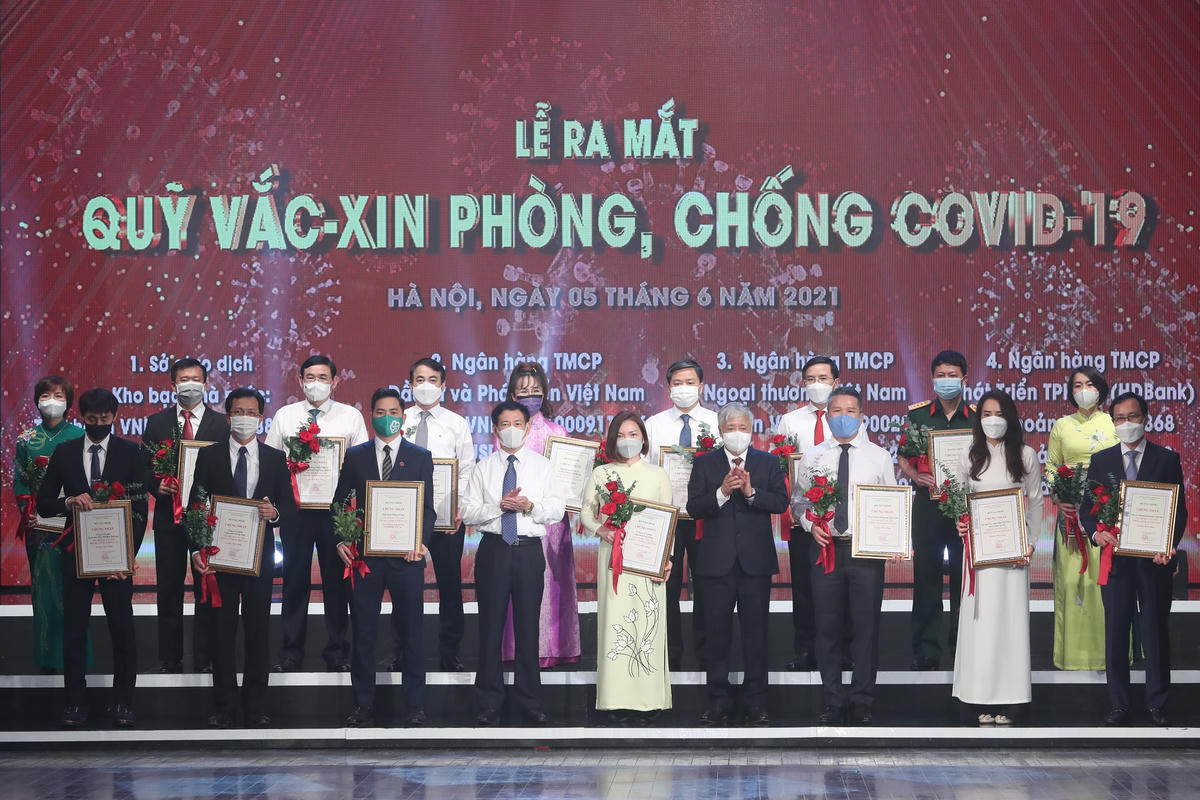 Chủ tịch UBTƯ MTTQ Việt Nam Đỗ Văn Chiến trao tặng chứng nhận cho các doanh nghiệp, tổ chức, cá nhân đã có nhiều đóng góp cho Quỹ vaccine phòng, chống Covid-19. Ảnh: Quang Vinh.