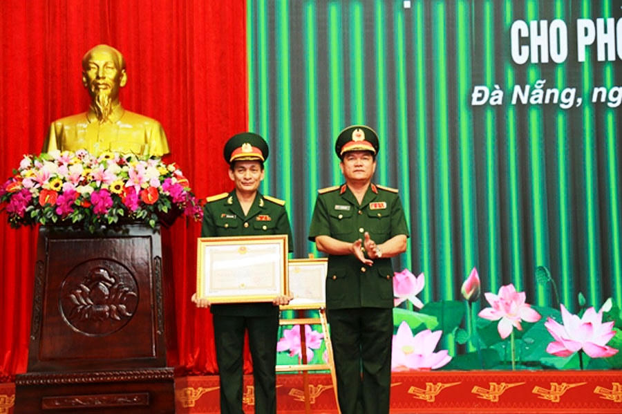 Thiếu tướng Võ Văn Hưng, Cục trưởng Cục Chính trị Quân khu 5 trao Huân chương Bảo vệ Tổ quốc hạng Nhất cho Phòng Tuyên huấn Quân khu 5. (Ảnh: Báo QĐND).