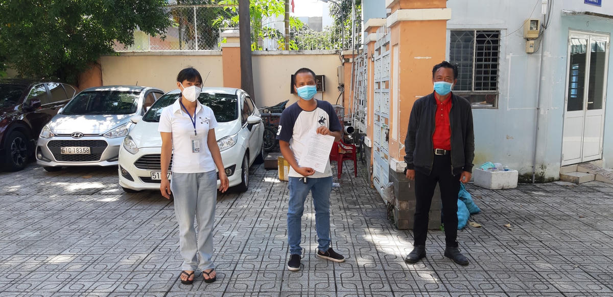Ông Đồng Văn Đầy được cán bộ Mặt trận phường 13 hỗ trợ và chuẩn bị lên xe trở lại quê hương.