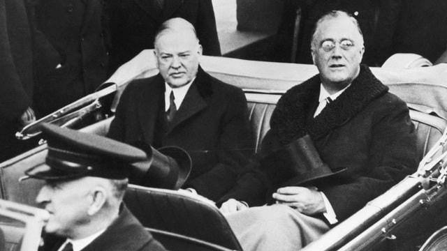 Ông Franklin Delano Roosevelt và Herbert Hoover cùng ngồi xe di chuyển đến lễ nhậm chức của ông Roosevelt năm 1933. Ảnh: Getty.  