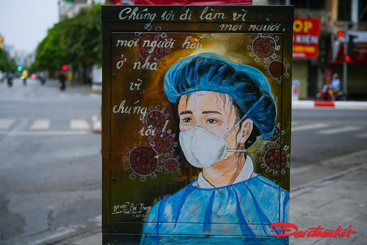 HÌnh ảnh bác sĩ trong bộ đồ bảo hộ được khắc hoạ tỉ mỉ cùng thông điệp: "Chúng tôi đi làm vì mọi người, mọi người hãy ở nhà vì chúng tôi". Ảnh: Quang Vinh. 