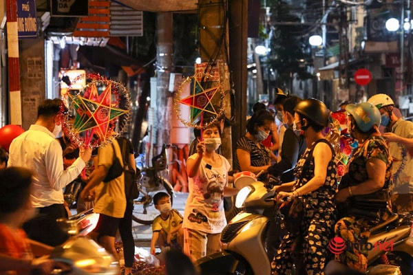 Người dân mua sắm đèn ông sao trên phố Hàng Mã. 