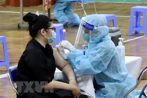 Nhân viên y tế tiêm vaccine cho người dân tại Nhà thi đấu Lãnh Binh Thăng (Quận 11, Thành phố Hồ Chí Minh). Ảnh: Hồng Giang/TTXVN.
