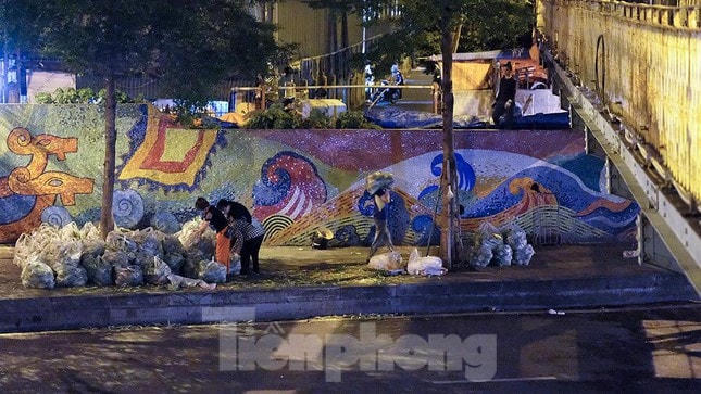 Tối 1/8, tiểu thương tập kết hàng bên ngoài đường Yên Phụ vì không được mang vào chợ qua cổng chính. Nguồn: Tiền Phong.